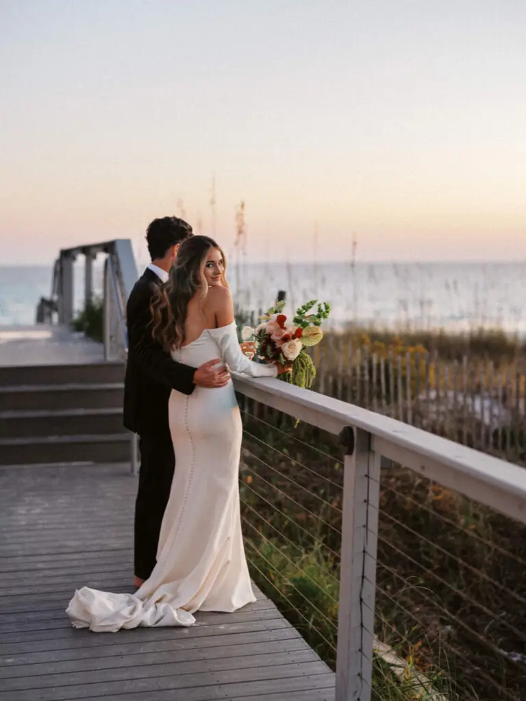 Kristie and Brandon at the beach starring at the sunset